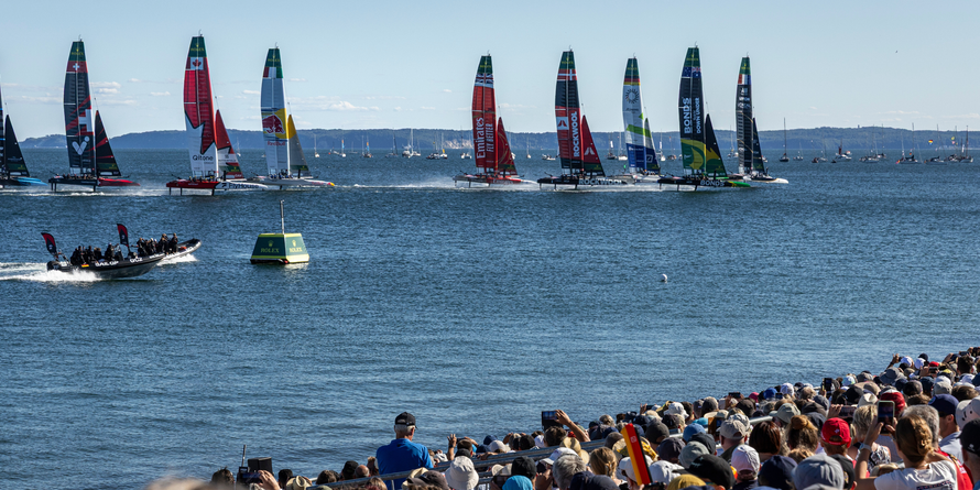 The SailGP F50 catamaran fleet is led by the France SailGP F50 catamaran helmed by Quentin Delapierre in-front of the SailGP Grandstand and SailGP Race Stadium on Race Day 2 of the Germany Sail Grand Prix in Sassnitz, Germany. Sunday 17 August 2025