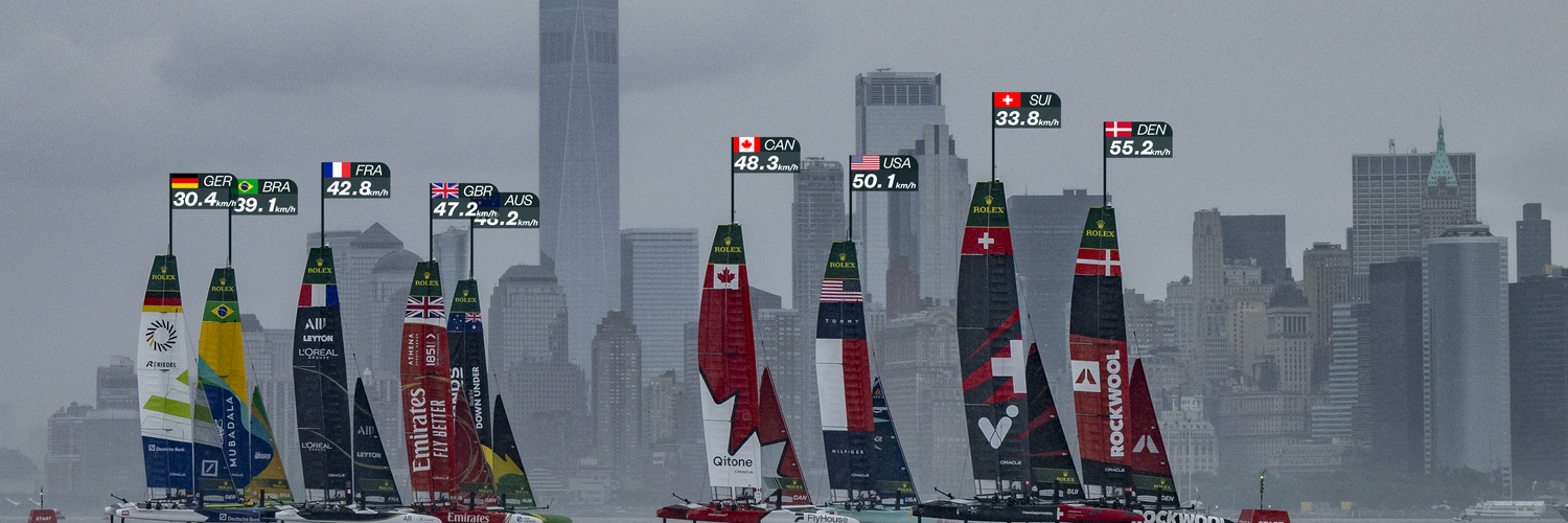 ROCKWOOL Denmark SailGP Team helmed by Nicolai Sehested and Switzerland SailGP Team helmed by Sebastien Schneiter lead the fleet past the One World Trade Centre and New York City skyline on Race Day 1 of the Mubadala New York Sail Grand Prix in New York, USA. Saturday 7 June 2025