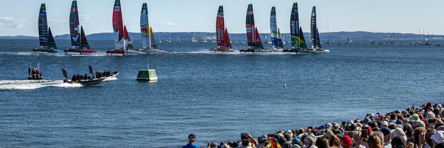 The SailGP F50 catamaran fleet is led by the France SailGP F50 catamaran helmed by Quentin Delapierre in-front of the SailGP Grandstand and SailGP Race Stadium on Race Day 2 of the Germany Sail Grand Prix in Sassnitz, Germany. Sunday 17 August 2025